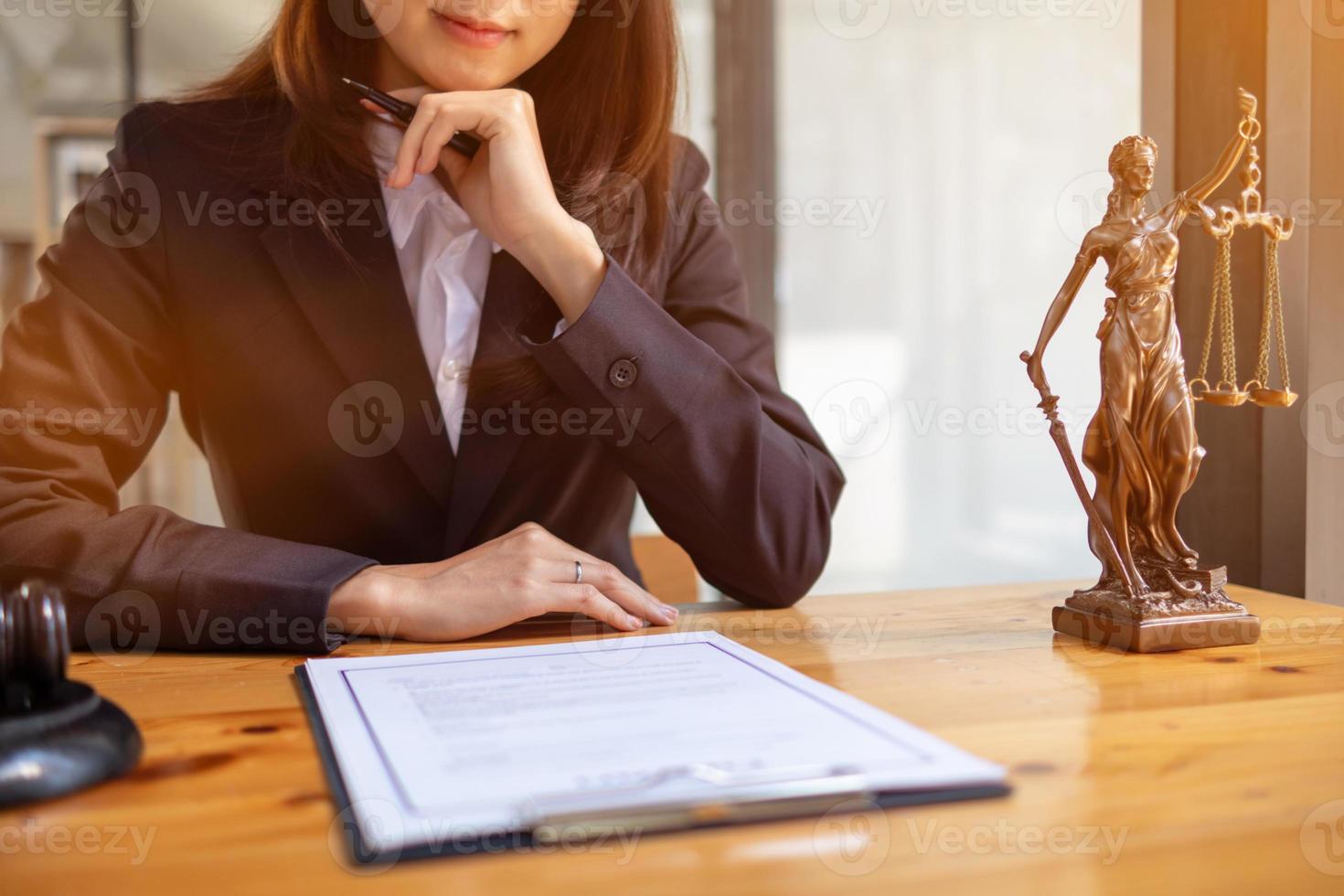 Lawyer holding contract documents in hand and preparing to sign a consulting contract for a team of business people who need legal advice to run their business in accordance with the law photo