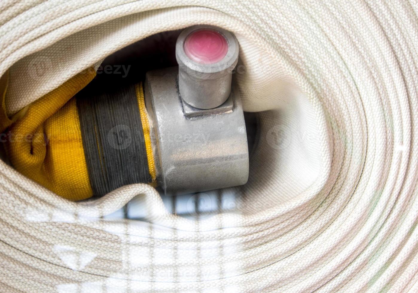 Roll of canvas hose in the emergency firefighting box photo