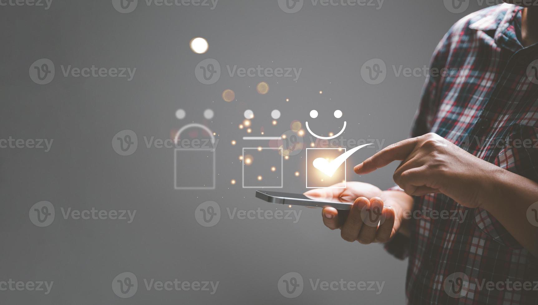 Customer service and Satisfaction concept, Business person are touching the virtual screen on happy Smiley face icon to give satisfaction in service. rating very impressed. customer service feedback. photo