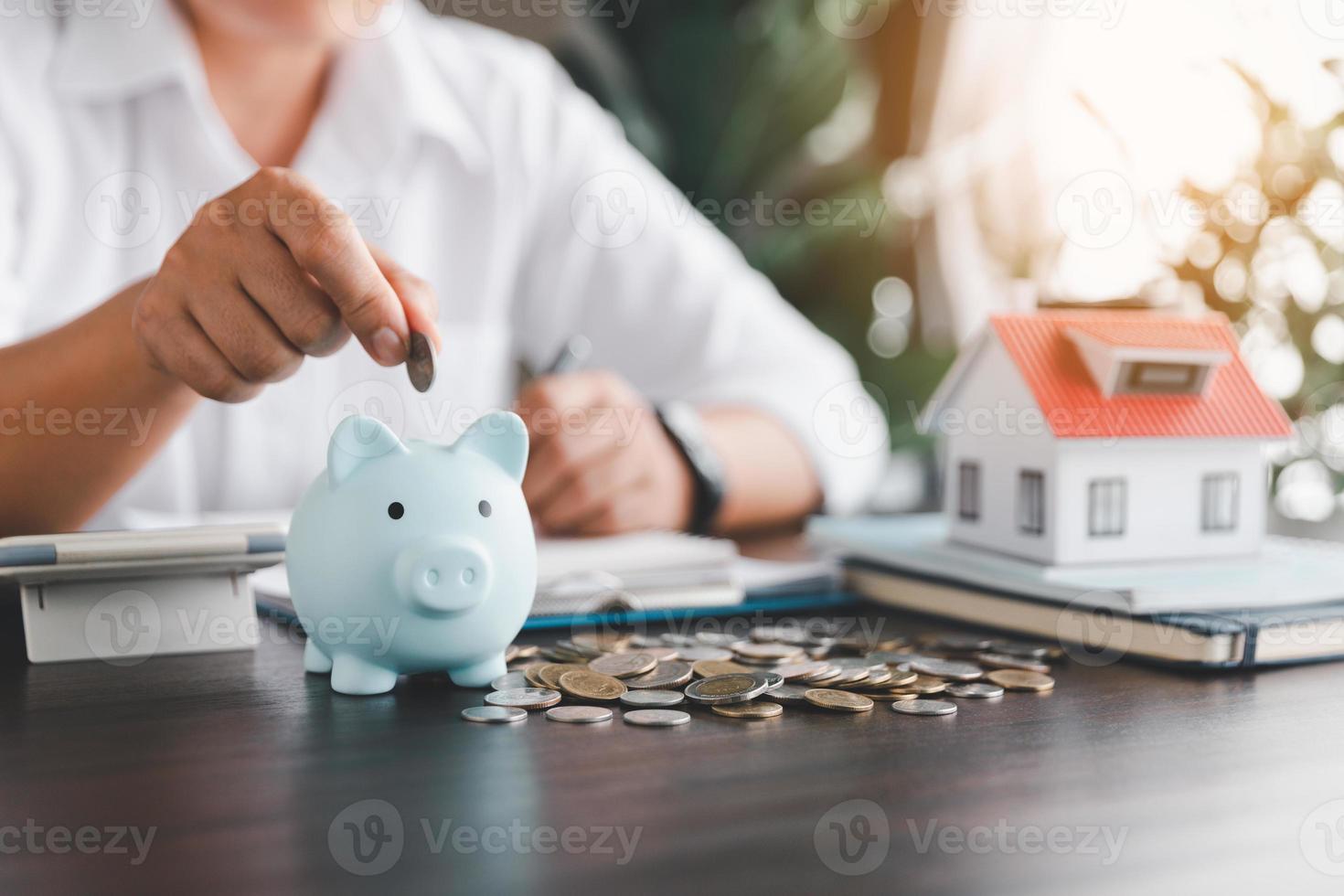 Saving investment home with loan finance money business concept. Investment banking finance for residential real estate business. Stack coins with model house for investment loans. Cash for taxes. photo