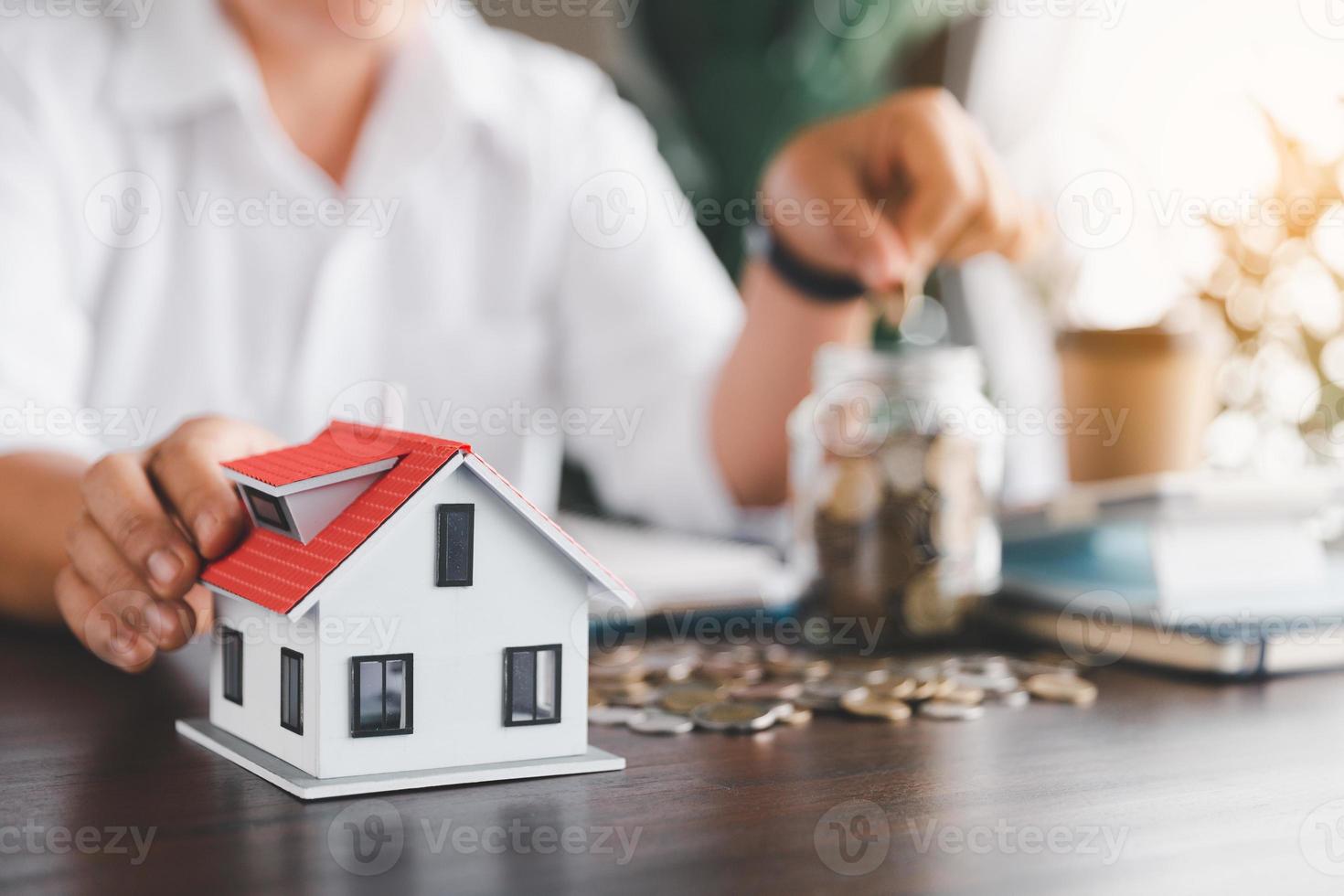 Saving investment home with loan finance money business concept. Investment banking finance for residential real estate business. Stack coins with model house for investment loans. Cash for taxes. photo