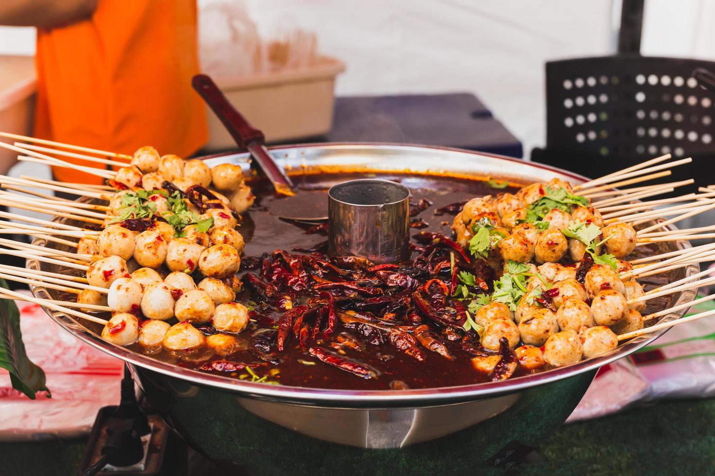 Food vendor pork meatballs in skewer with sweet chili sauce in a tray. photo