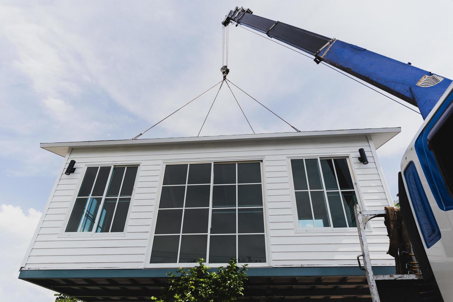 Crane lifting a knock down private house. photo