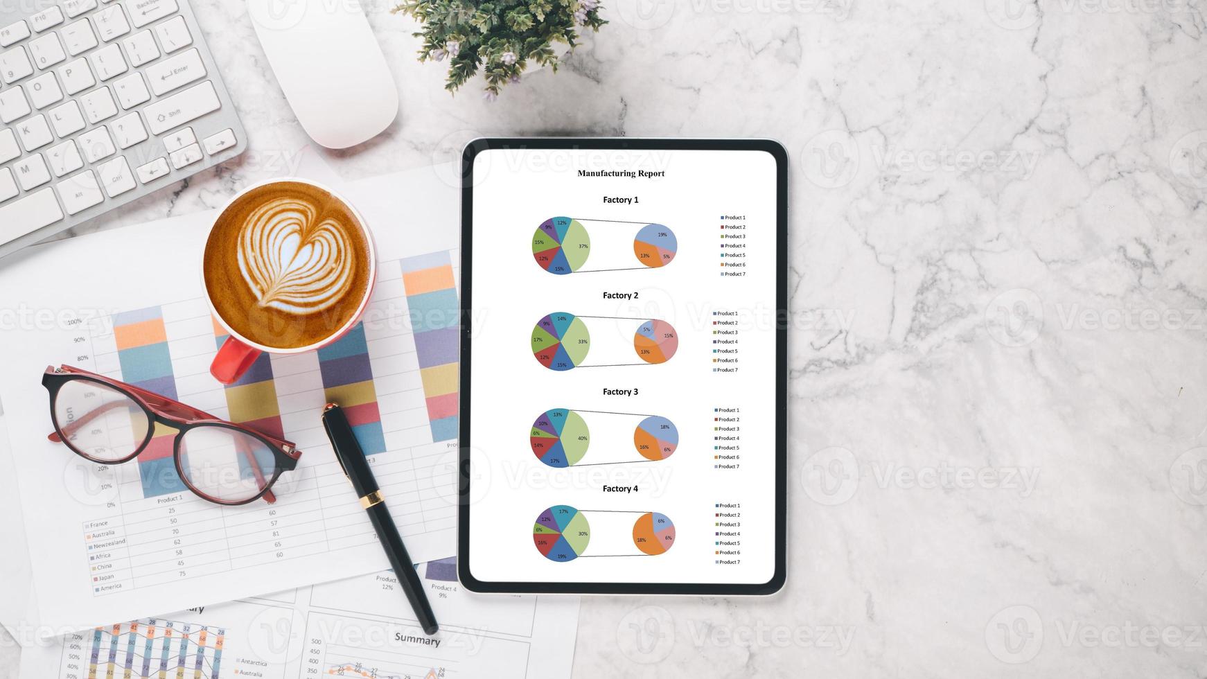 Tablet with charts and reports on office desk workplace. Top view flat lay photo