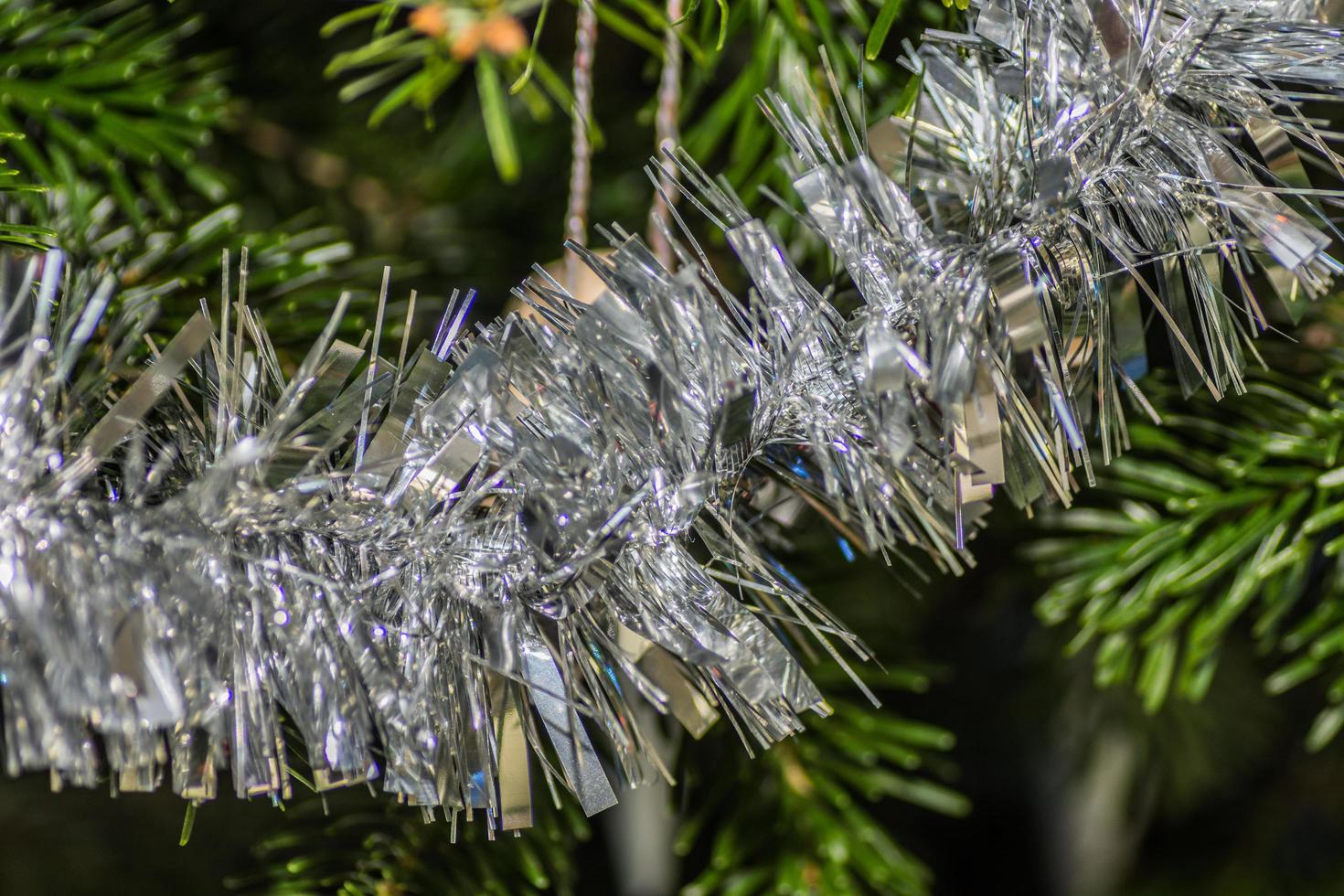 silver tinsel at the christmas tree detail photo