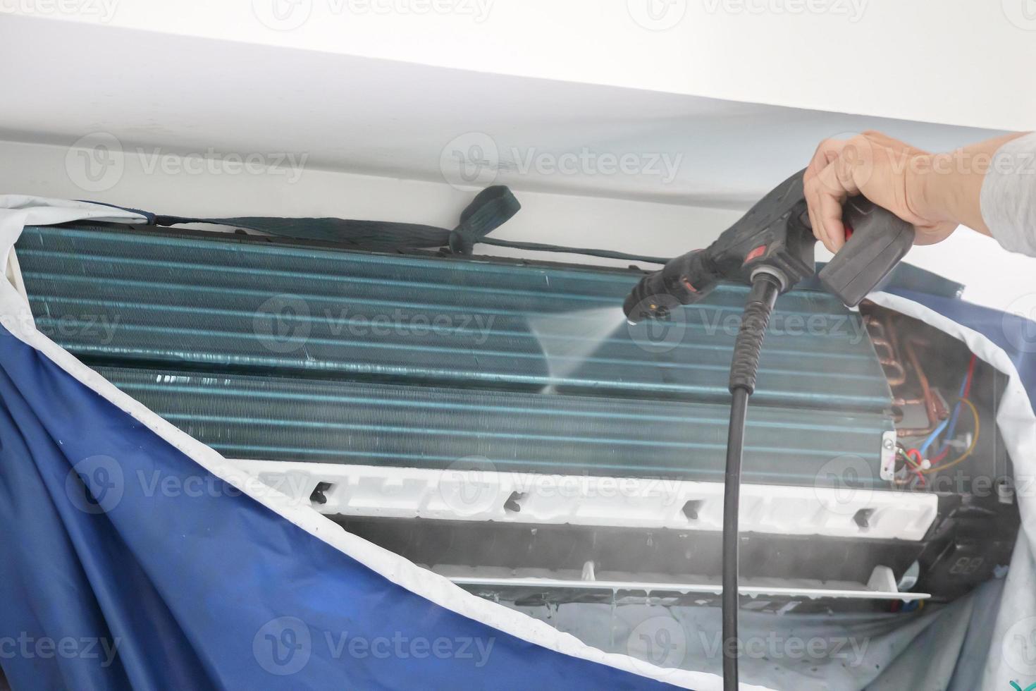 air conditioning cleaning service with water spray photo