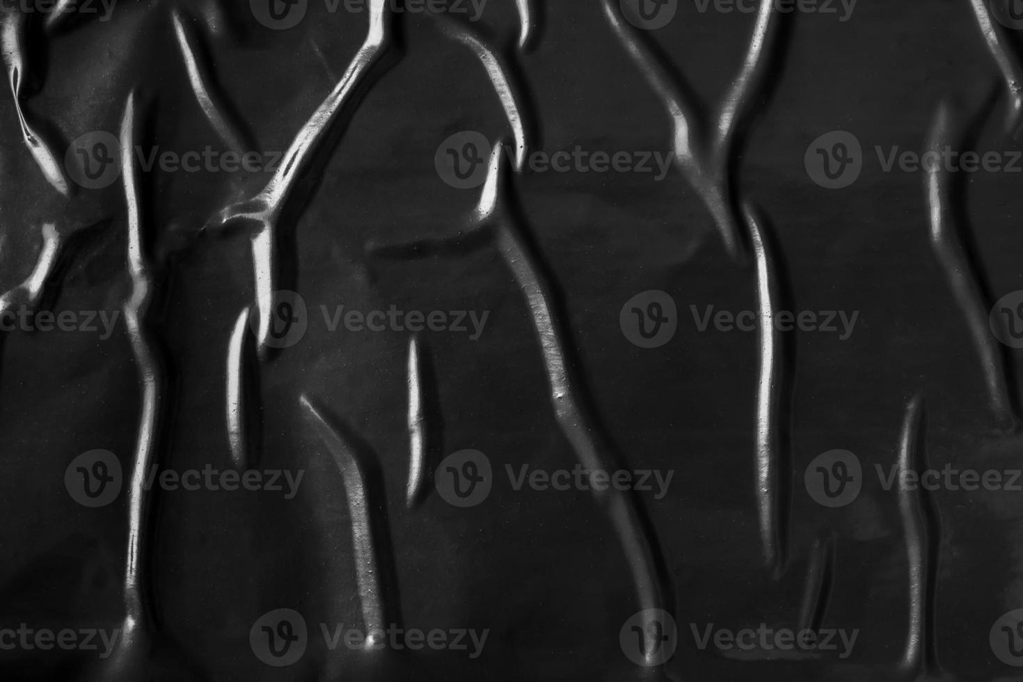 black crumpled and creased plastic poster texture background photo