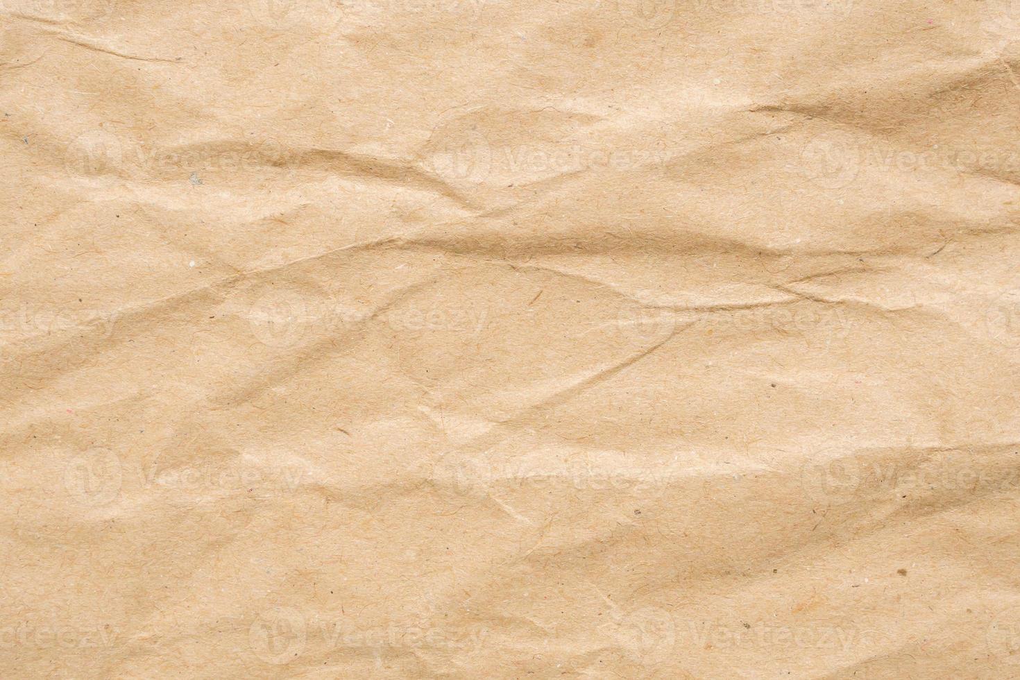 Abstract crumpled and creased recycle brown paper texture background photo