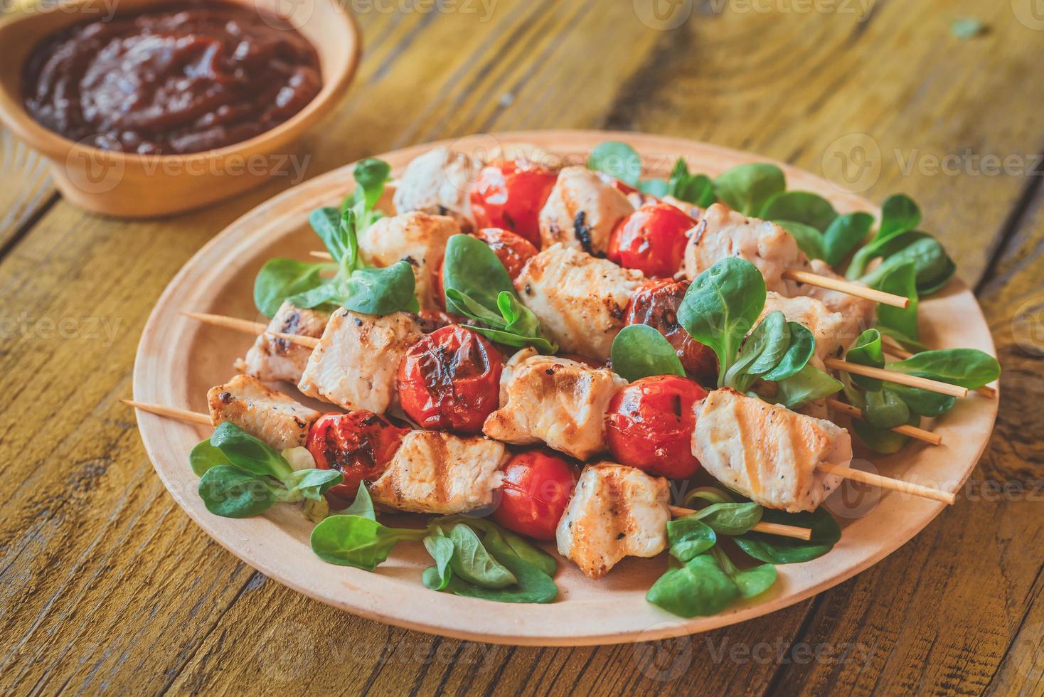 Grilled chicken skewers on the plate photo