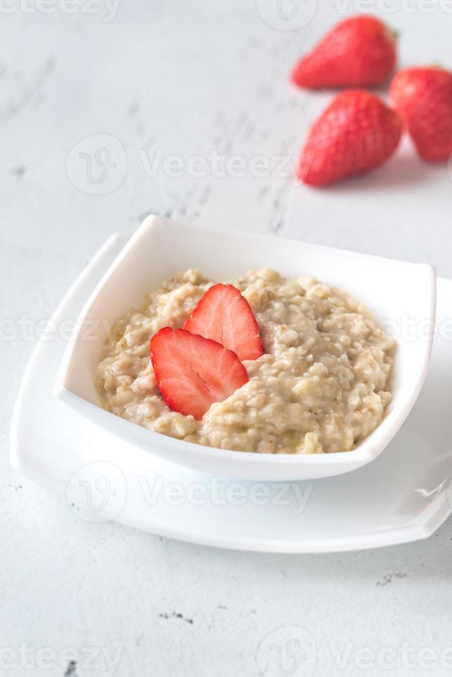 Bowl of oats with fresh strawberries photo