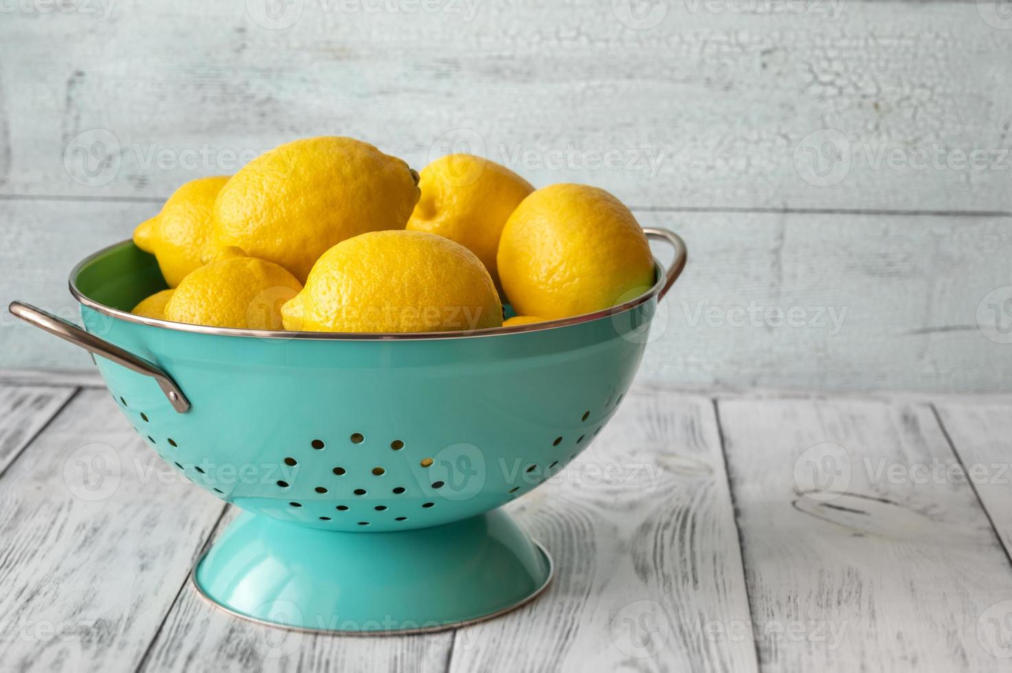 Fresh lemons in the colander photo