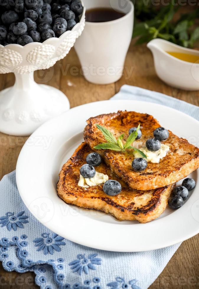 French toasts with fresh blueberries and maple syrup photo