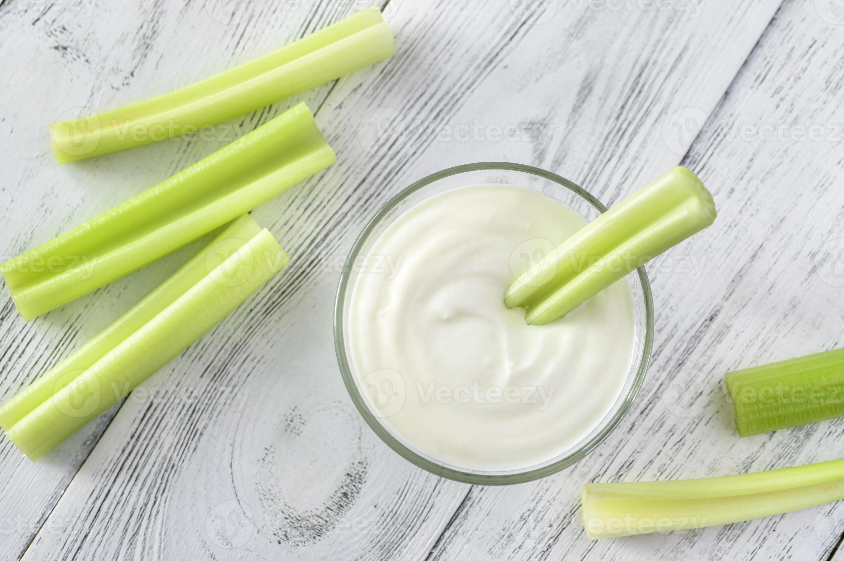Celery stalk dipped in yogurt 23160157 Stock Photo at Vecteezy