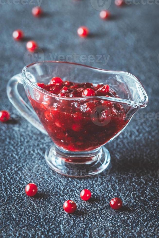 Cranberry sauce in glass gravy boat photo