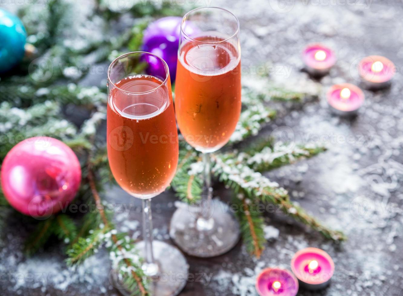 Two glasses of champagne with Christmas tree branch photo