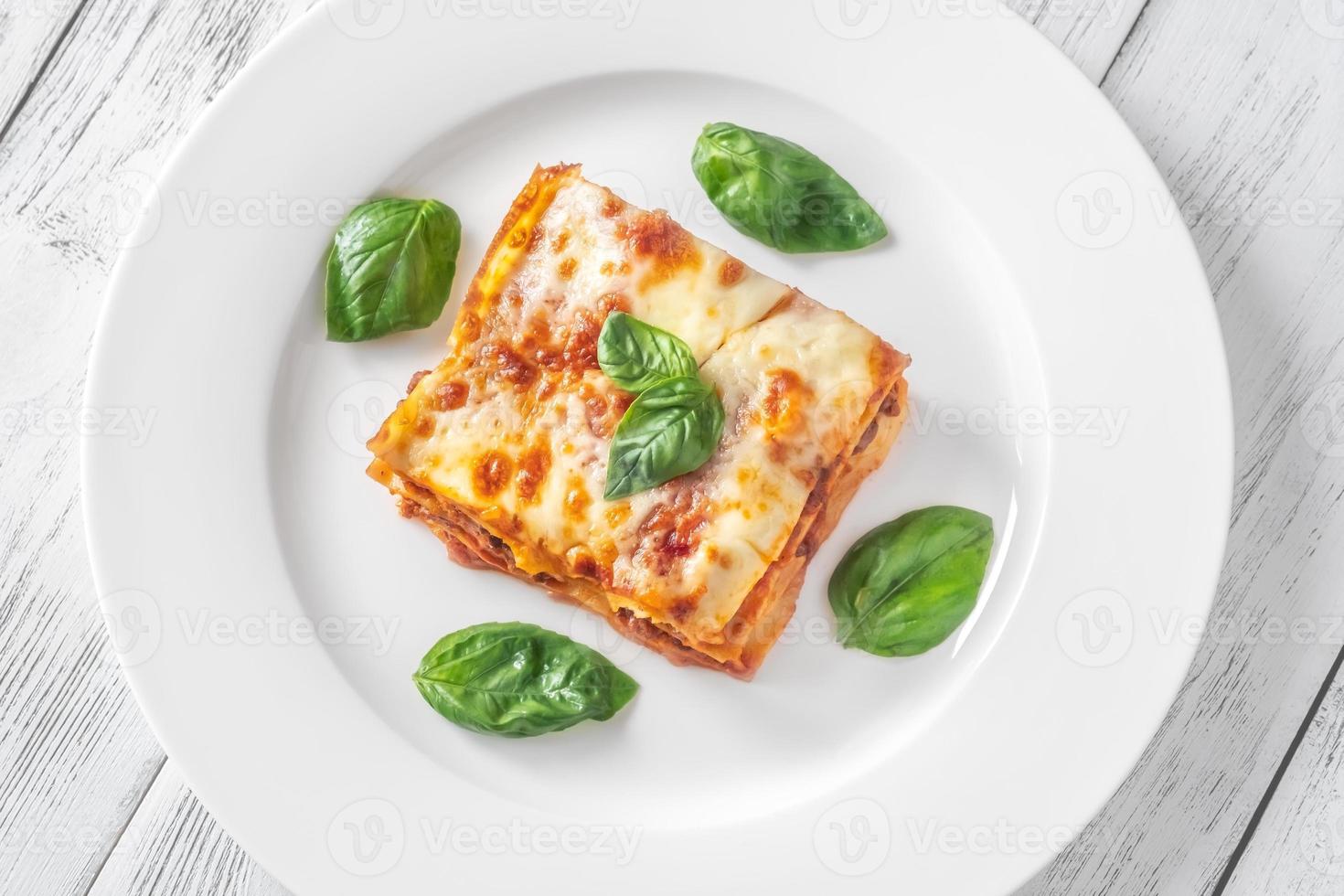 Portion of lasagne on white plate photo