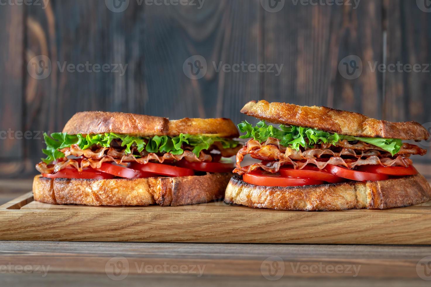 BLT sandwiches on the wooden board photo