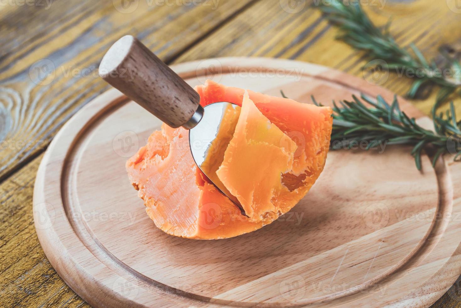 Mimolette cheese on the wooden board photo