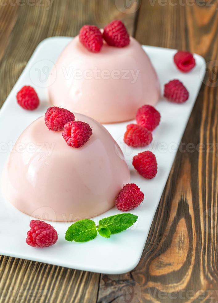 Dessert puddings with raspberries photo