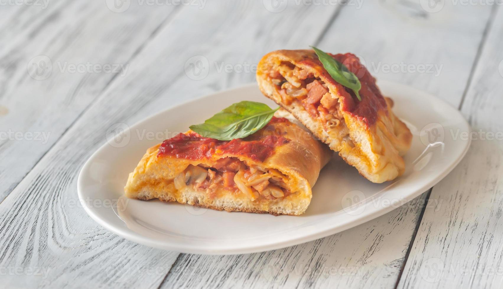 Homemade calzone on the plate photo
