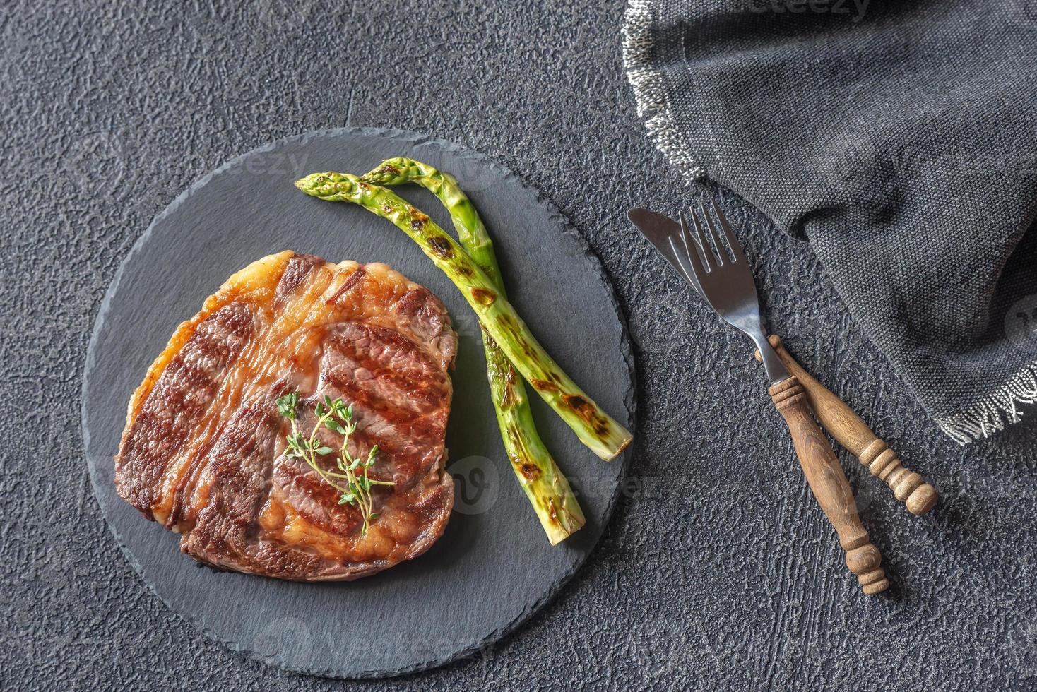 Grilled beef steak with asparagus photo