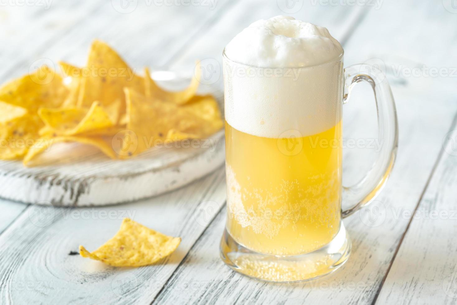 Mug of beer with tortilla chips photo