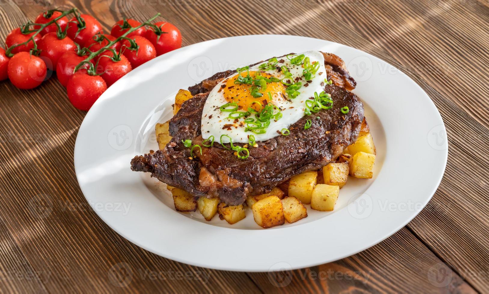 Beefsteak with fried egg photo