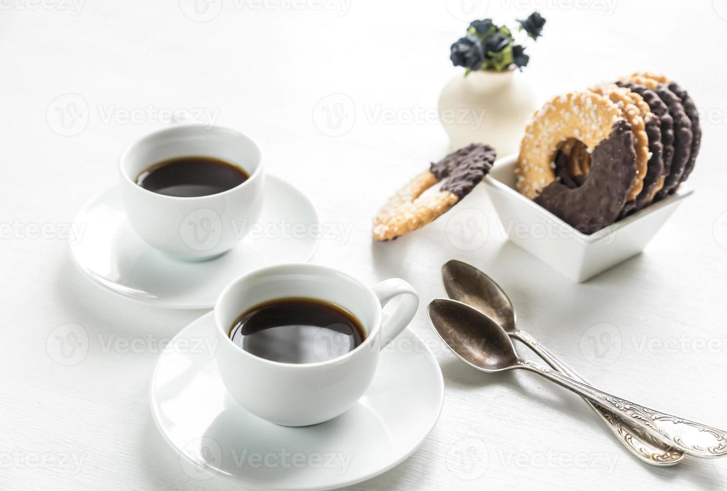 Chocolate cookies with two cups of coffee photo