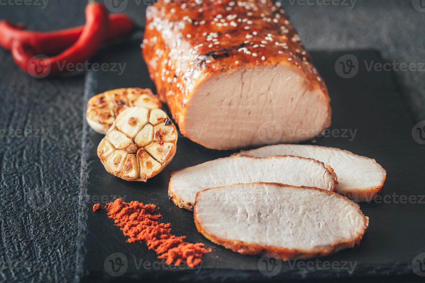 Baked meat with paprika on the black sone board photo