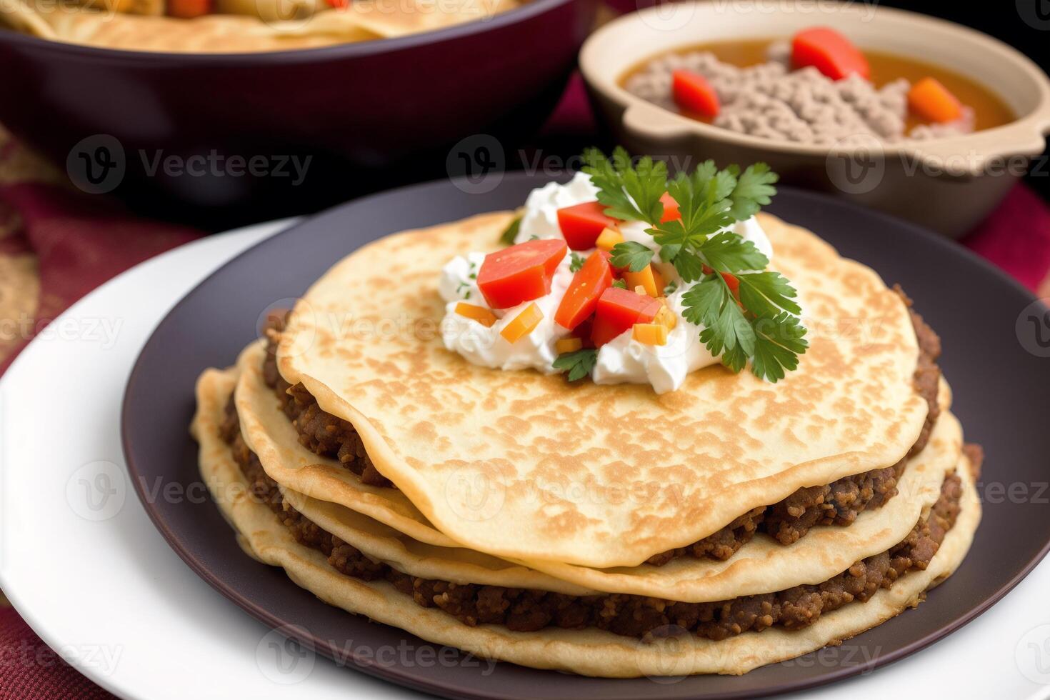 Russian cuisine. Meat dumplings stuffed with vegetables and sour cream. Pancakes with minced meat and vegetables. photo