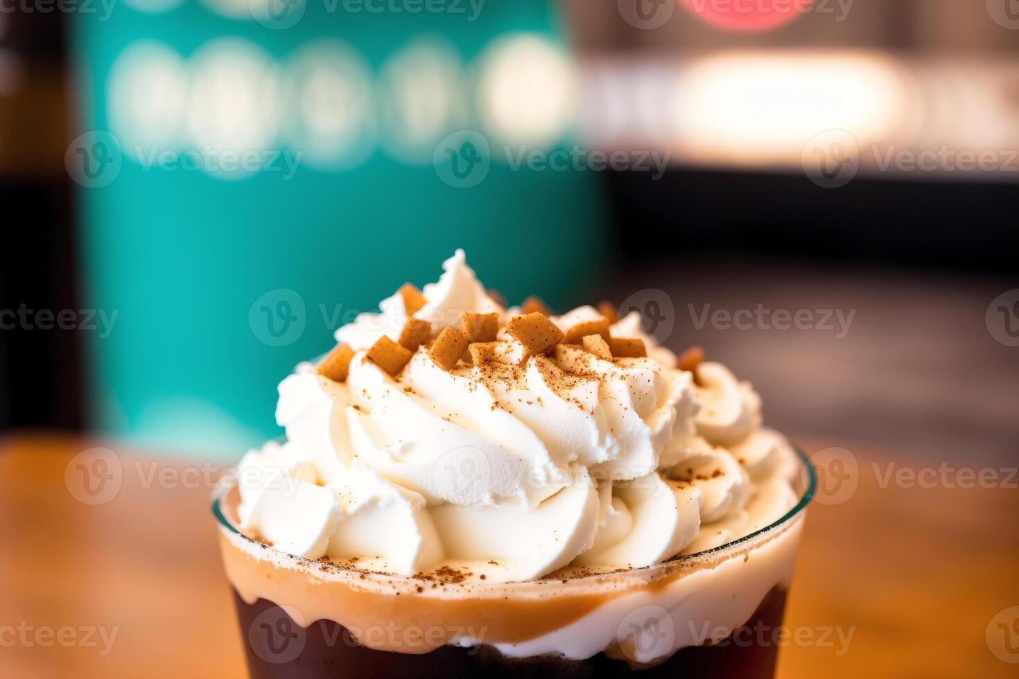 Iced coffee with whipped cream in a glass on a wooden table. photo