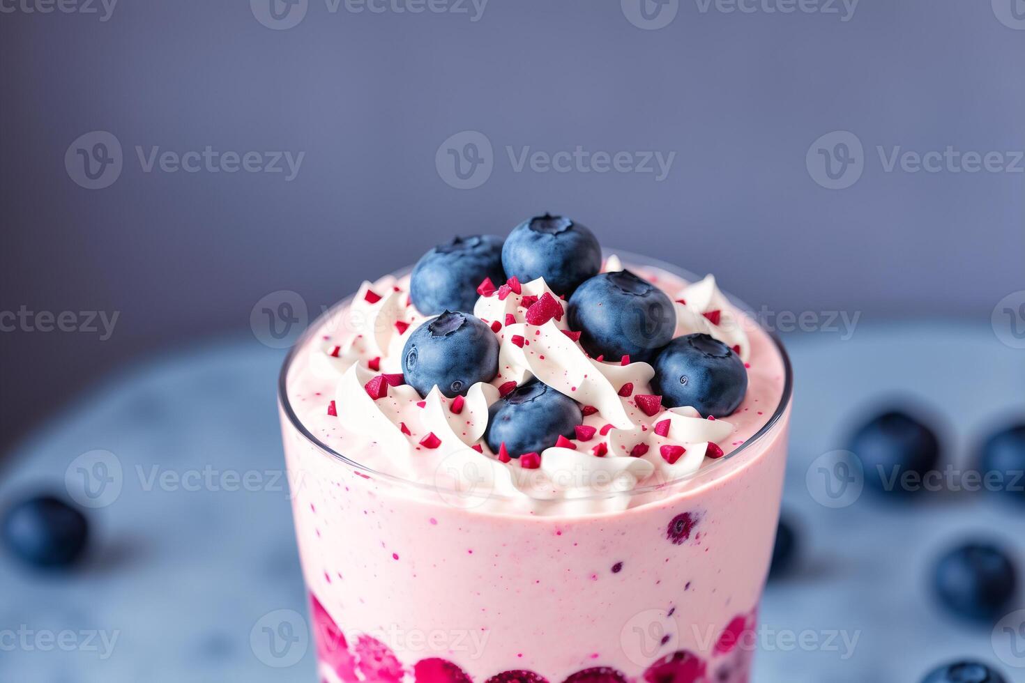 A glass of milkshake with whipped cream and blackberries.Strawberry milkshake, Raspberry milkshake. photo