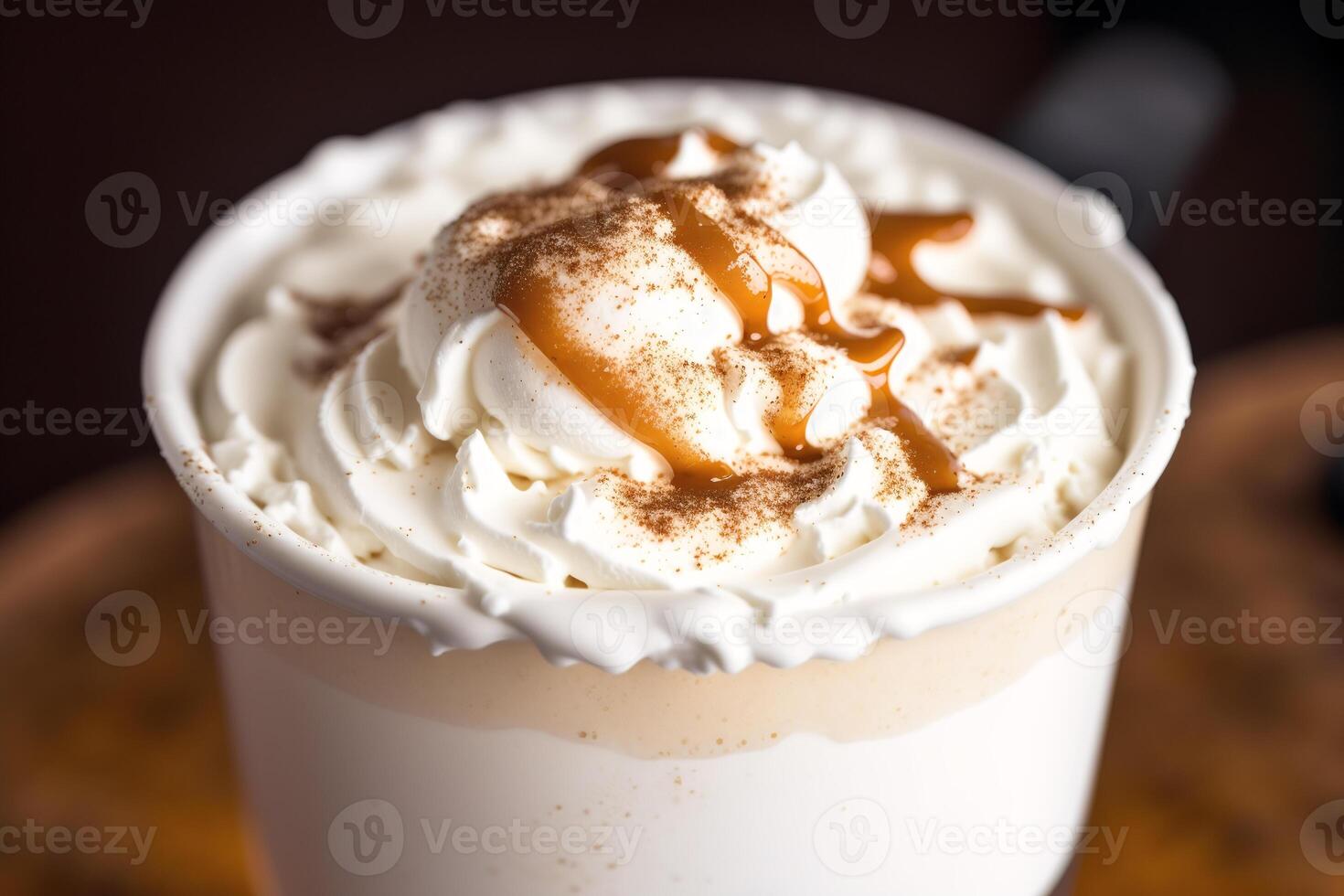 Iced coffee with whipped cream in a glass on a wooden table. photo