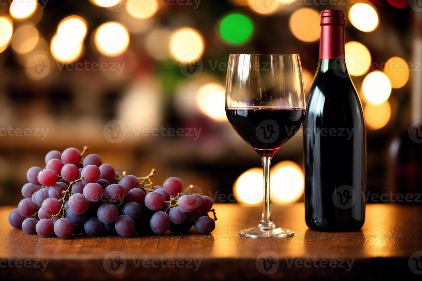 Glass of red wine and grapes on a wooden table.Bottle and glass of red wine with grapes. photo