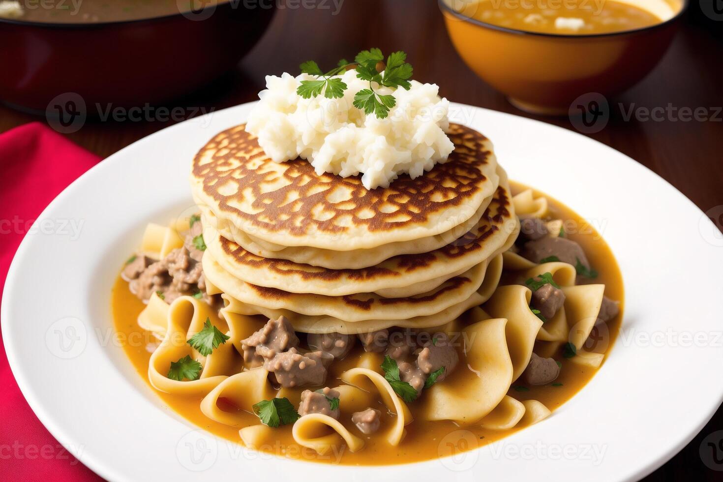 Russian cuisine. Meat dumplings stuffed with vegetables and sour cream. Pancakes with minced meat and vegetables. photo