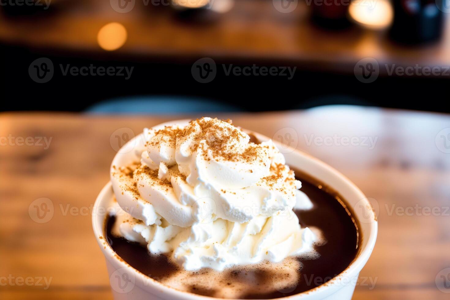 Iced coffee with whipped cream in a glass on a wooden table. photo