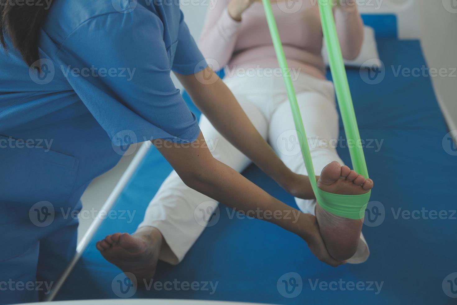 Patient doing some special exercises under supervision in a room photo