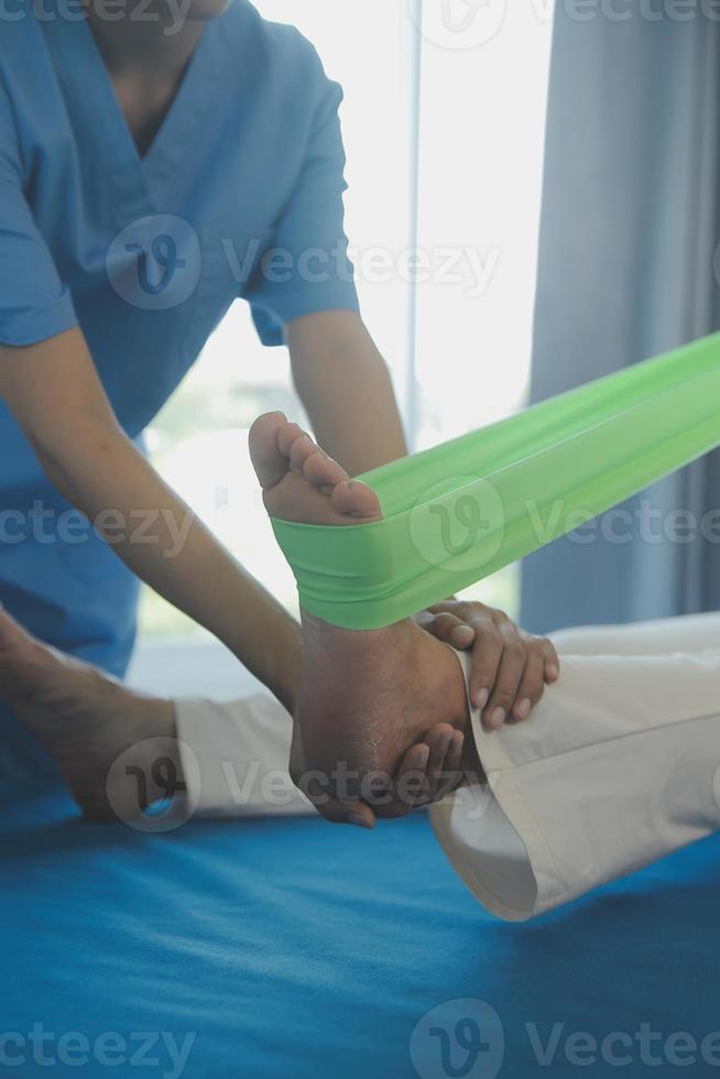 Patient doing some special exercises under supervision in a room photo