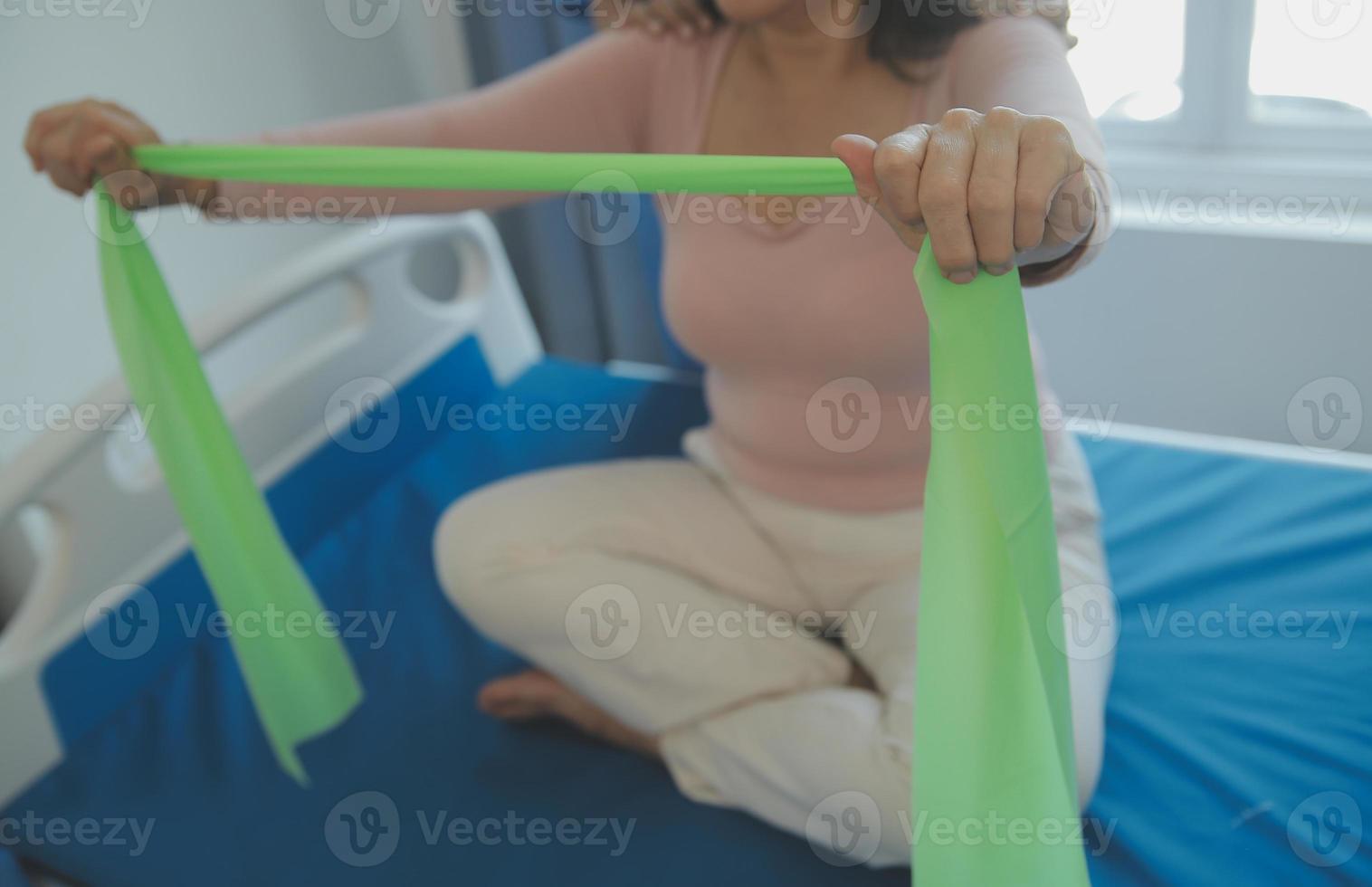 Patient doing some special exercises under supervision in a room photo