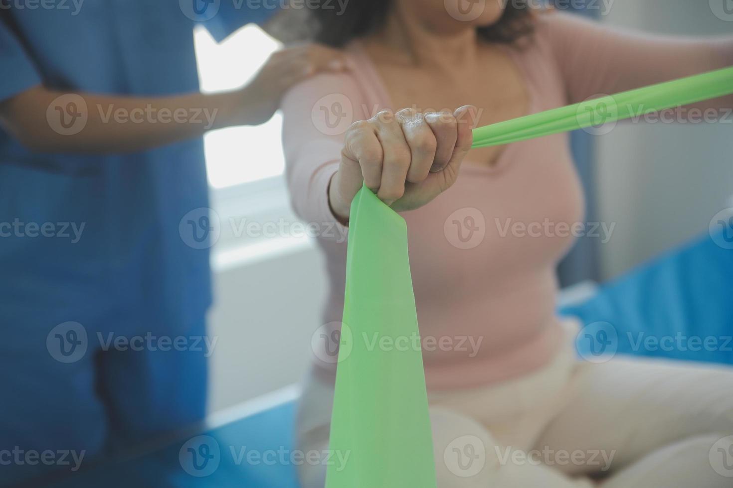Patient doing some special exercises under supervision in a room photo