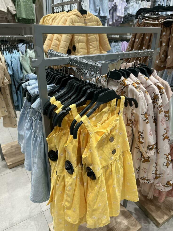 Baby clothes shop. Large assortment of colorful clothes. photo