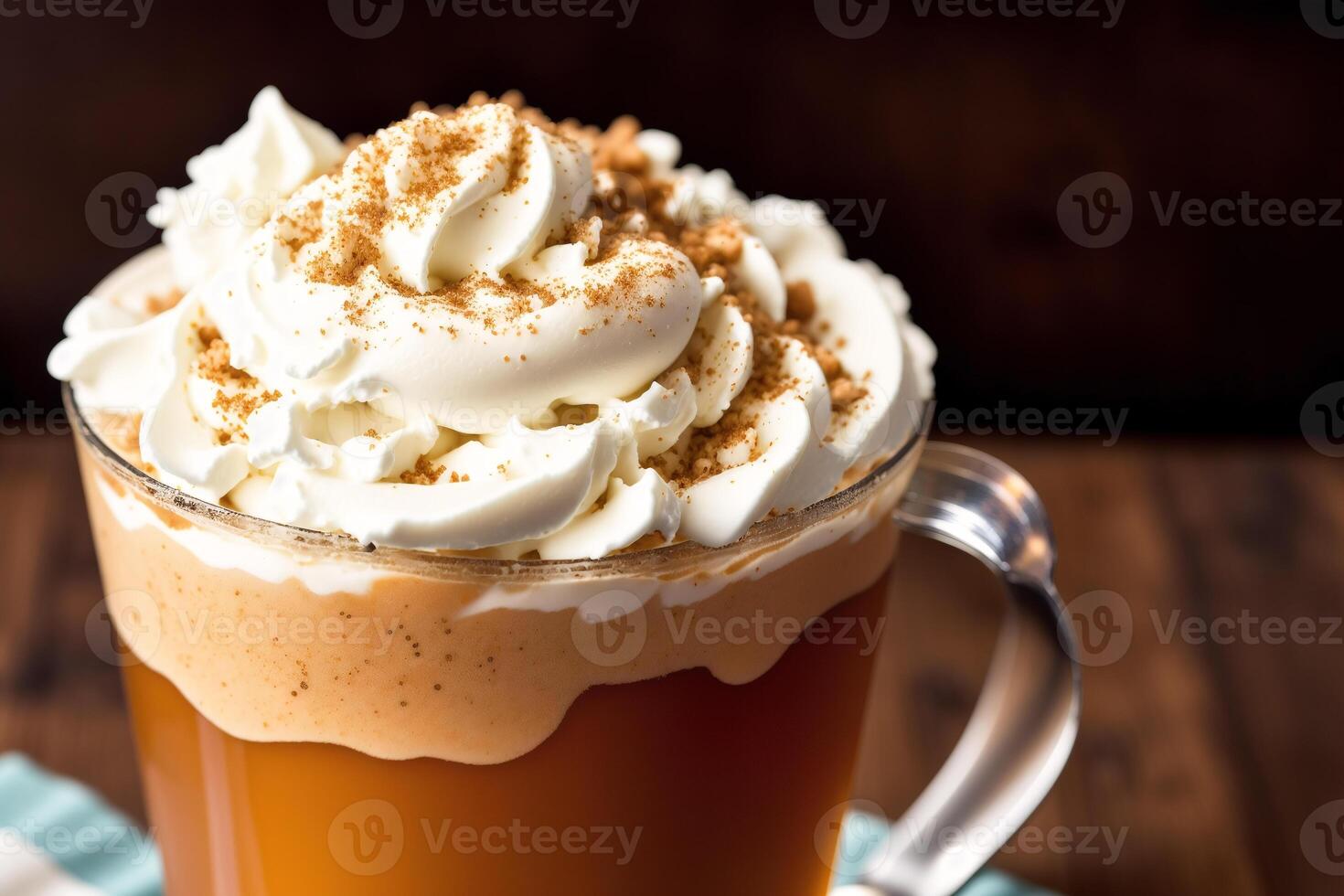 Iced coffee with whipped cream in a glass on a wooden table. photo