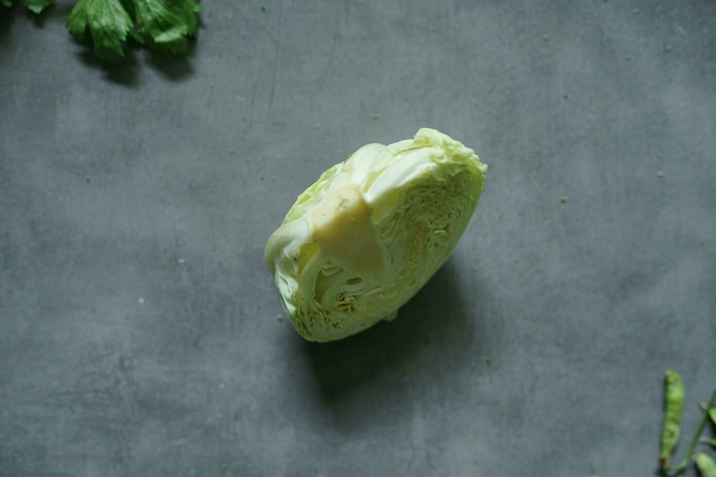 fresh cabbage and fresh vegetables from top view on concerete background photo