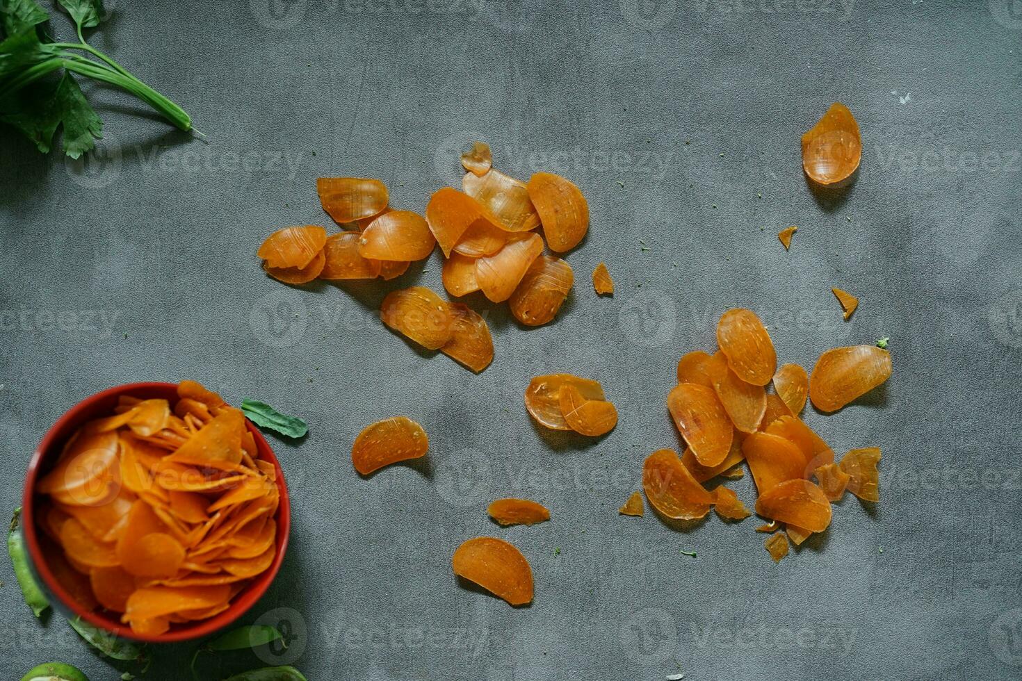 raw yellow crackers in a bowl on a concrete background photo