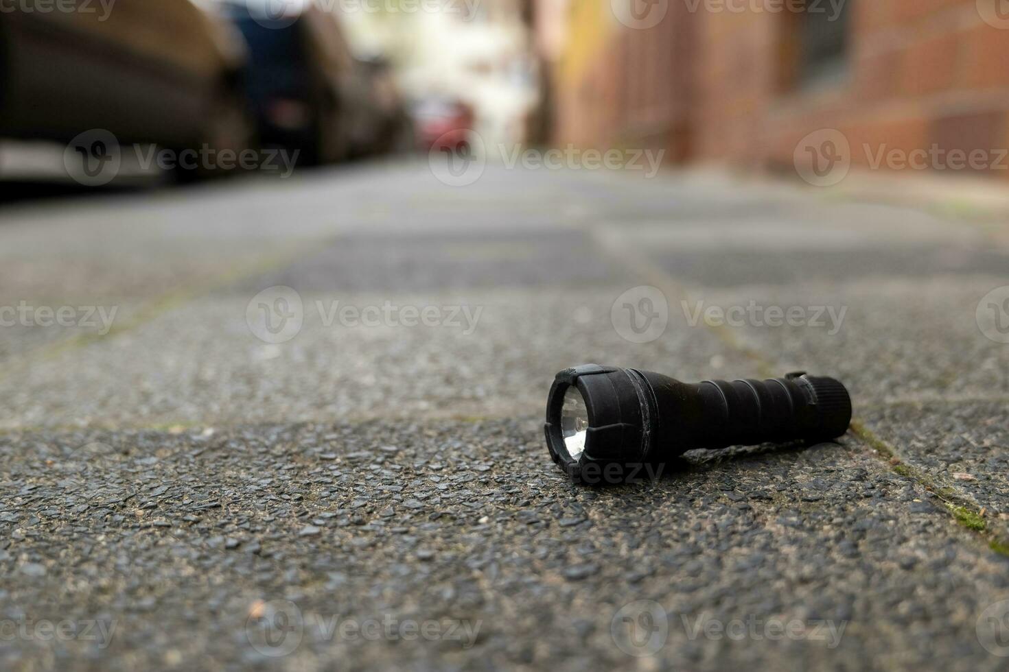 a flashlight on a street photo