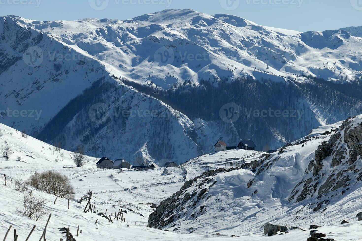 Aerial drone view of mountain village during winter. Snow white landscape and mountaineer lifestyle. photo