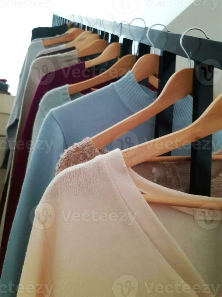 Clothes are hung neatly in preparation for sale. photo