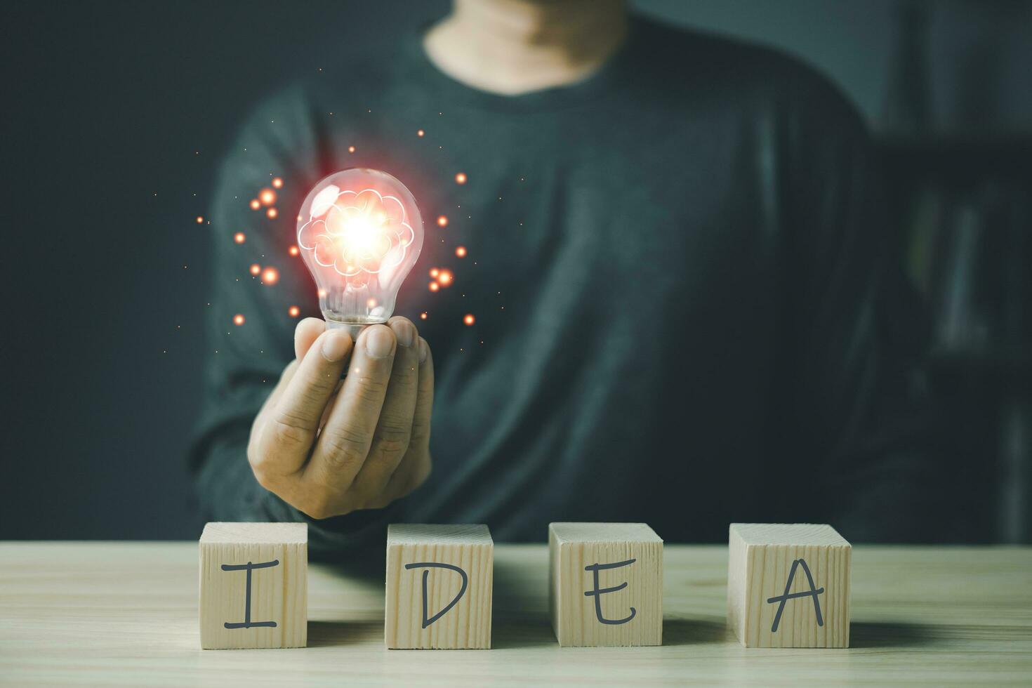 person hand holding power lightbulb and the wooden block has the word idea, inspiration, creativity and imagination concept, innovation technology success business. photo