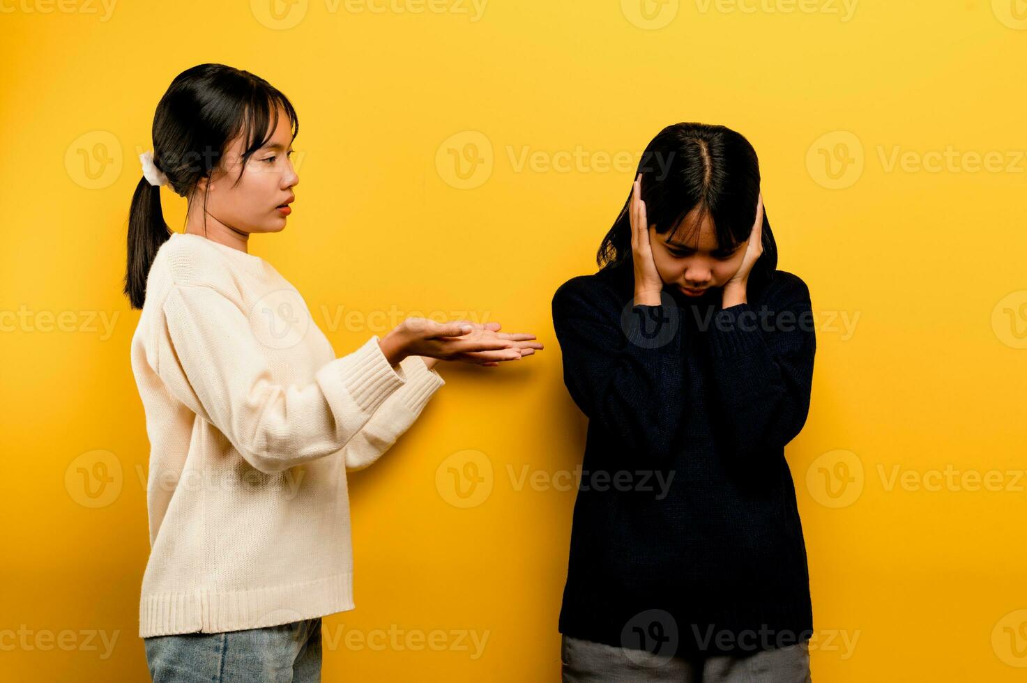 the intensity of communication misunderstanding Two friends don't talk to each other after a fight. behind the yellow background Filming of content about conflicts and misunderstandings photo