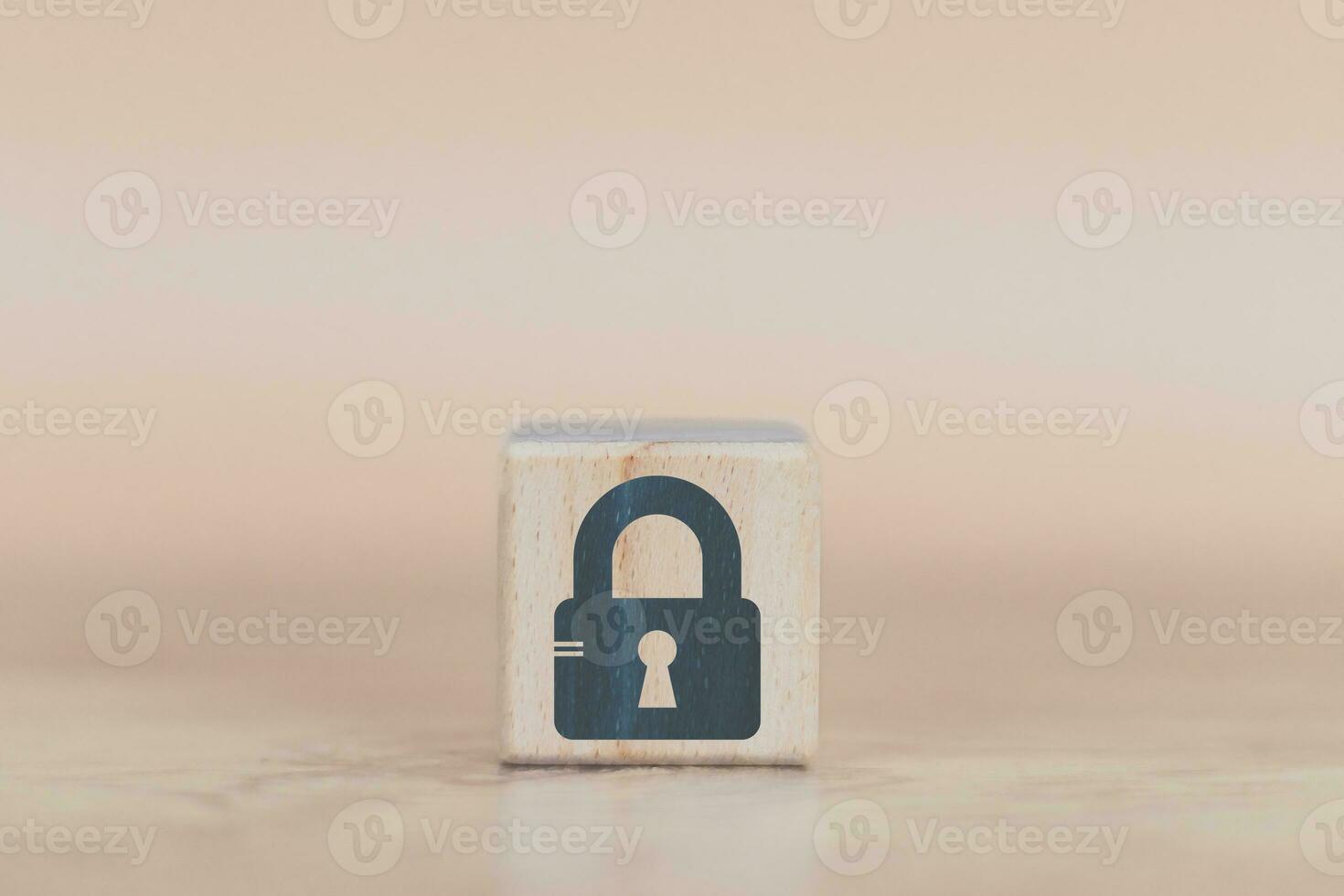 cyber security wood cube concept man hand laying down a wood cube with a padlock icon to convey protection  with danger to data and assets photo